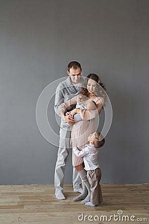 Young adult family with an infant and a child in a studio Stock Photo