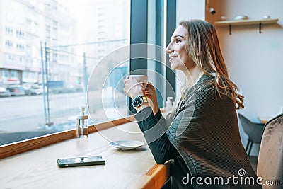 Young adult forty years blonde woman in casual clothes drinking coffee at cafe Stock Photo