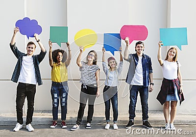 Young adult friends holding up copyspace placard thought bubbles Stock Photo