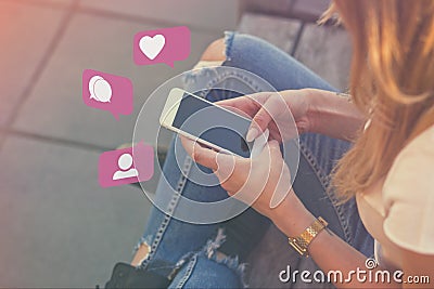 Young Adult Girl Influencer Using Social Media on Smartphone on Outdoor, Like, Follower, Comment Bubble Icons Stock Photo