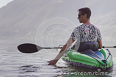 Young man kayaking on the lake Stock Photo