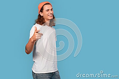 Young adult guy blink eye, pointing at camera Stock Photo