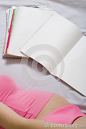 Young adult woman reading journal Stock Photo