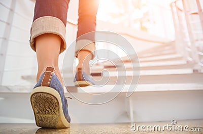 Young adult woman walking up the stairs Stock Photo