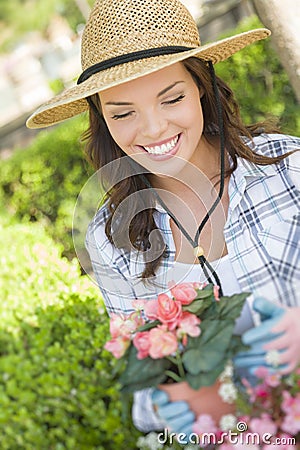 Young Adult Woman Wearing Hat Gardening Outdoors Stock Photo