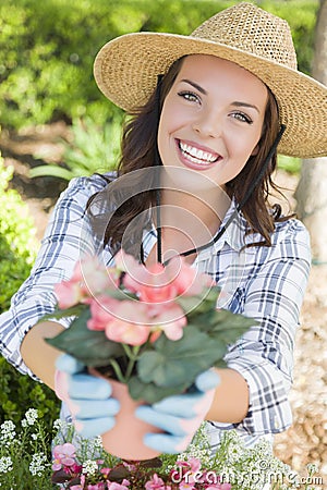 Young Adult Woman Wearing Hat Gardening Outdoors Stock Photo