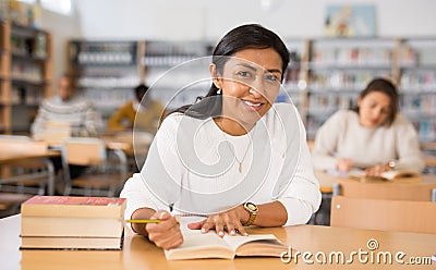 Young adult woman studying in public library Stock Photo