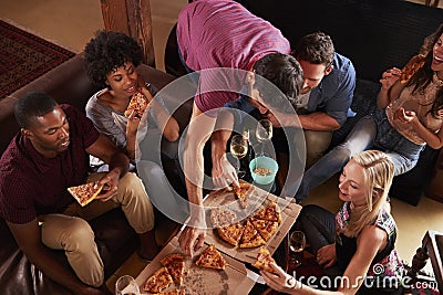 Young adults eating pizzas at a party at home, elevated view Stock Photo