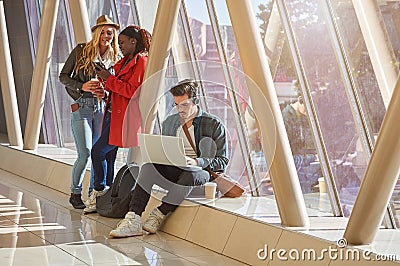 3 young adults entrepreneurs or students group mixed race around Stock Photo