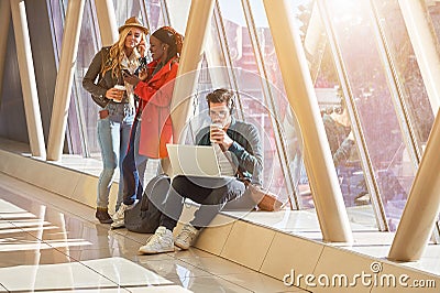 3 young adults entrepreneurs or students group mixed race around Stock Photo