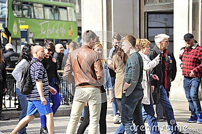 Young adults talking on a street in London Editorial Stock Photo