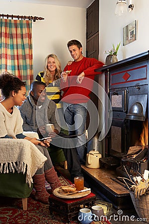 Young adults making toast on open fire Stock Photo