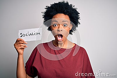 Young African American afro politician woman with curly hair socialist party member scared in shock with a surprise face, afraid Stock Photo