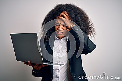 Young african american business woman with afro hair using computer laptop from job stressed with hand on head, shocked with shame Stock Photo