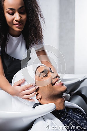 Young african american client smiling near Stock Photo