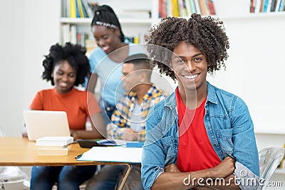 Young african american computer science student with group of students Stock Photo