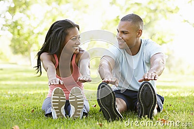 Young African American Couple Exercising In Park Stock Photo