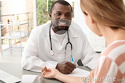 Young African-American doctor checking patient`s Stock Photo