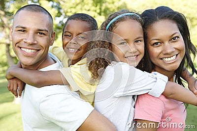 Young African American Family Relaxing In Park Stock Photo