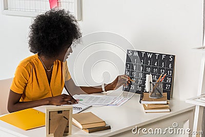 young african american freelancer checking calendar at workplace Stock Photo