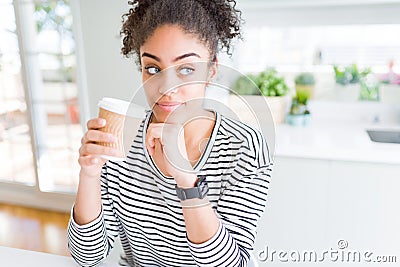 Young african american girl drinking a coffee on a take away paper cup serious face thinking about question, very confused idea Stock Photo