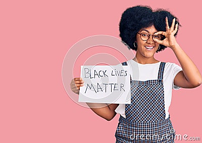 Young african american girl holding black lives matter banner smiling happy doing ok sign with hand on eye looking through fingers Editorial Stock Photo