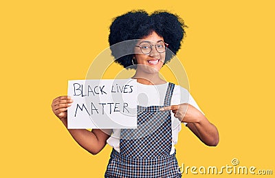 Young african american girl holding black lives matter banner smiling happy pointing with hand and finger Editorial Stock Photo