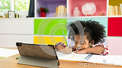 Young African American kid girl studying using digital tablet, preschool child study at home school. homeschooling concept Stock Photo