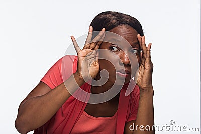 Young African American woman looking or taking a peek, horizontal Stock Photo