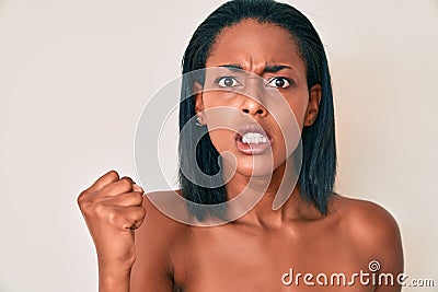 Young african american woman naked over background annoyed and frustrated shouting with anger, yelling crazy with anger and hand Stock Photo