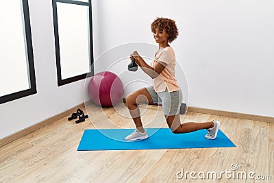Young african american woman smiling confident training using ketlebell at sport center Stock Photo
