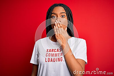 Young african american woman wearing sarcasm coments text on t-shirt over red background cover mouth with hand shocked with shame Stock Photo