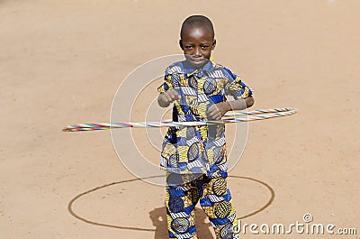 Young African Boy Playing Smiling Laughing Outdoors with Hula Ho Stock Photo