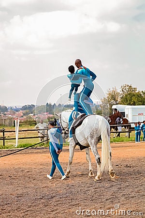 Young African children performing acrobatics on horse back Editorial Stock Photo