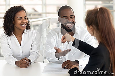 Young african couple starting family life getting keys from realtor Stock Photo