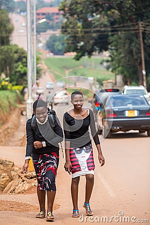 Young African female students walking on road side Editorial Stock Photo