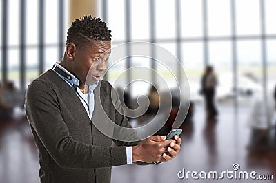 Young african guy looking at cell phone Stock Photo