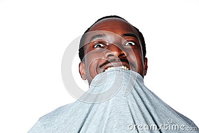 Young african man biting his t-shirt Stock Photo