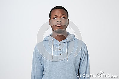 Young african man with guilty confused expression. Human negative face expression Stock Photo