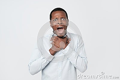 Young african man having asthma attack or choking can not breath suffering from respiration problems Stock Photo