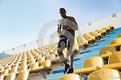 Young african man runner in sport clothes running downstairs a Stock Photo