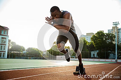 Young african runner running on racetrack Stock Photo