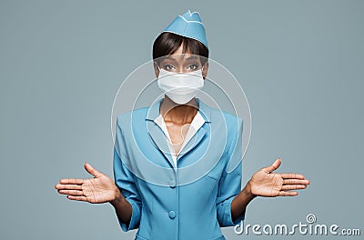 Young african stewardess wearing an antiviral mask on her face. Stock Photo