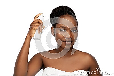 Young african woman with hairspray Stock Photo