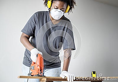 Young african woman renovating the house DIY concept Stock Photo