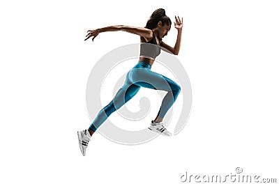 Young african woman running or jogging isolated on white studio background. Stock Photo