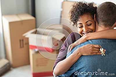 Woman hugging man and holding home keys Stock Photo