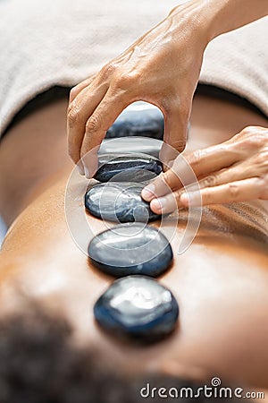 Hot stone massage at spa Stock Photo