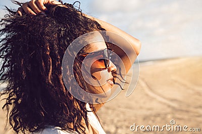 Young afro american woman in sunglasses enjoying sun Stock Photo