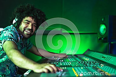 Young Afro man working in music recording studio - Male audio engineer mixing a sound Stock Photo